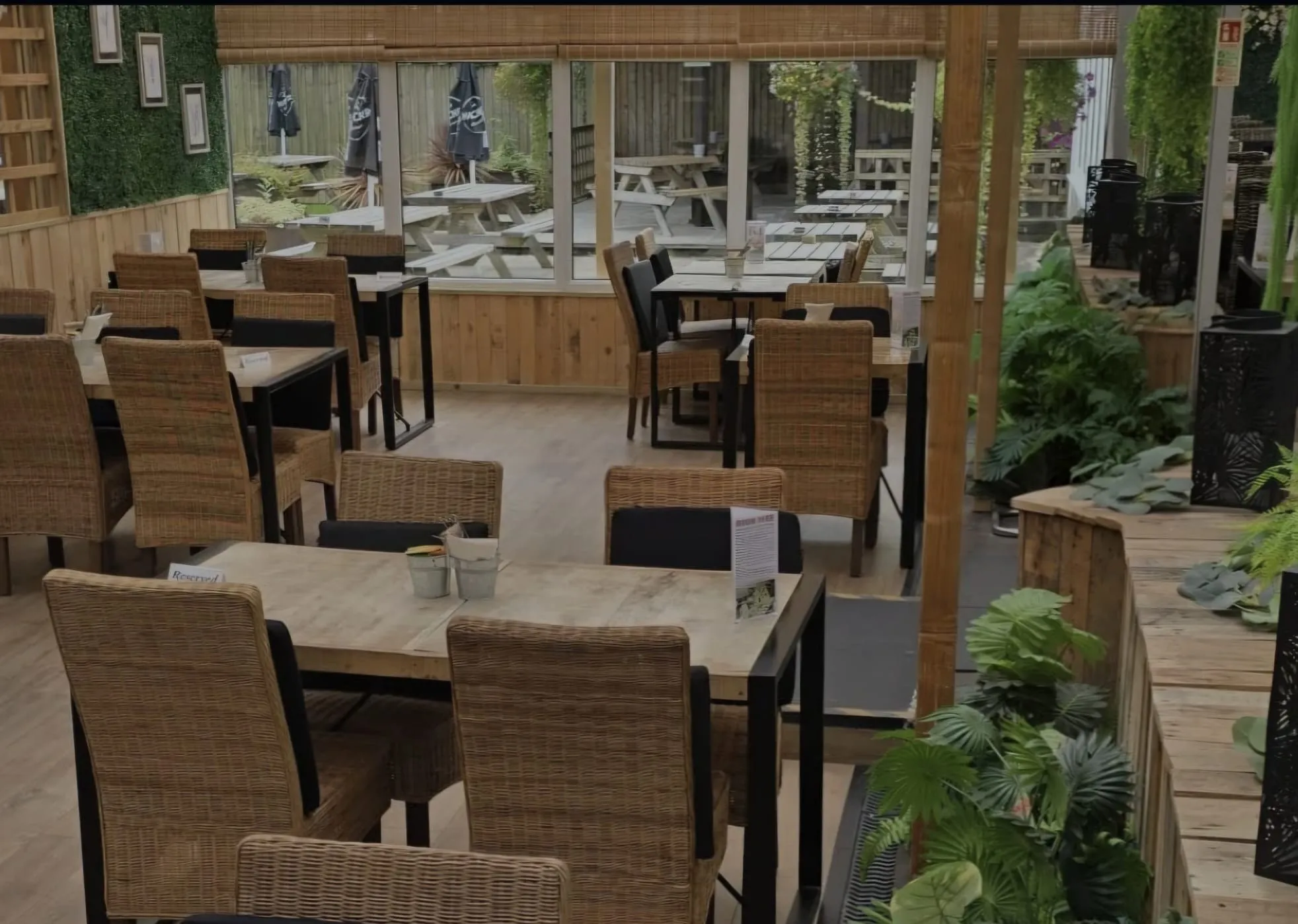 Looking through the covered courtyard to the conservatory, planting along the edge