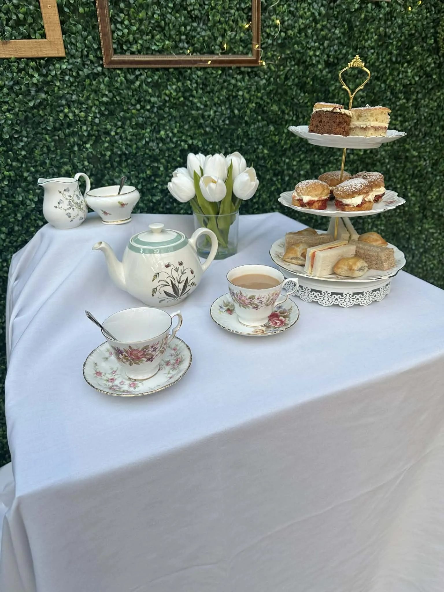 An afternoon tea laid on vintage china with a tiered stand