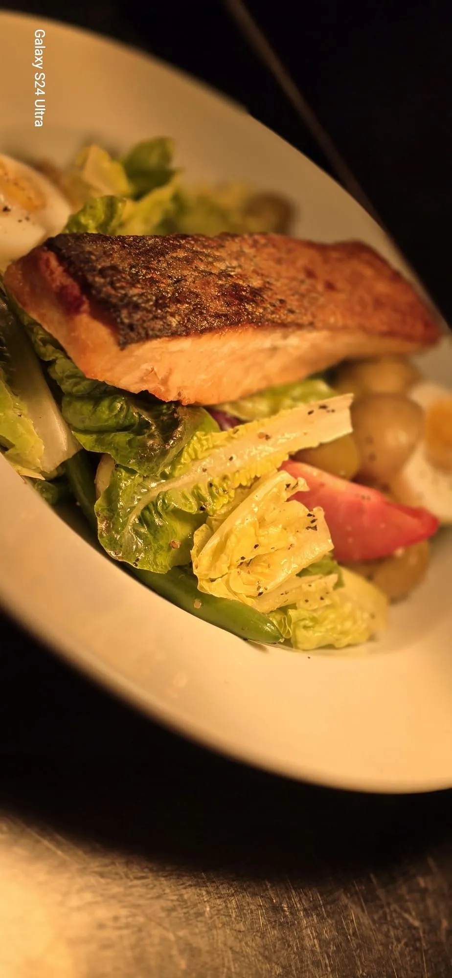 Crispy skinned salmon on a salad of new potatoes, egg and green beans