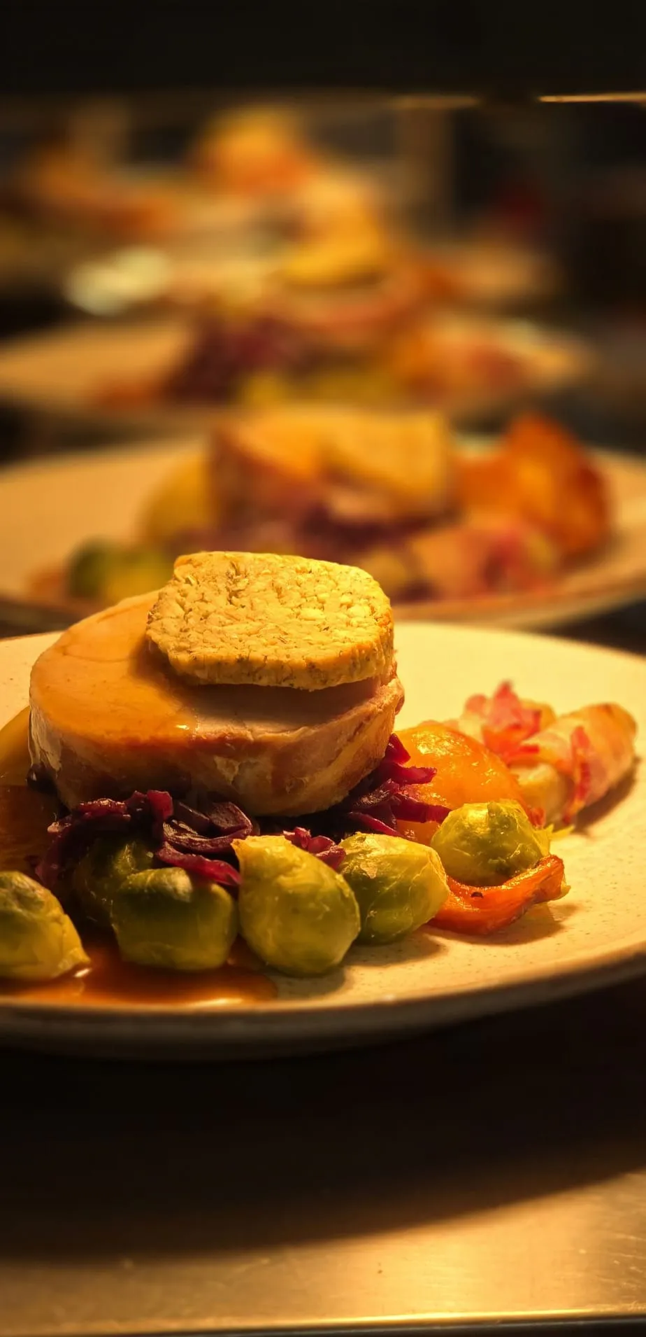 Roast pork loin with stuffing, red cabbage and roast vegetables