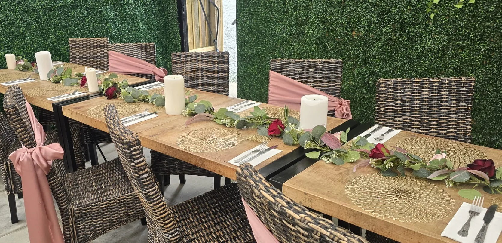 Covered terrace tables with dusky pink sashes and rose garlands